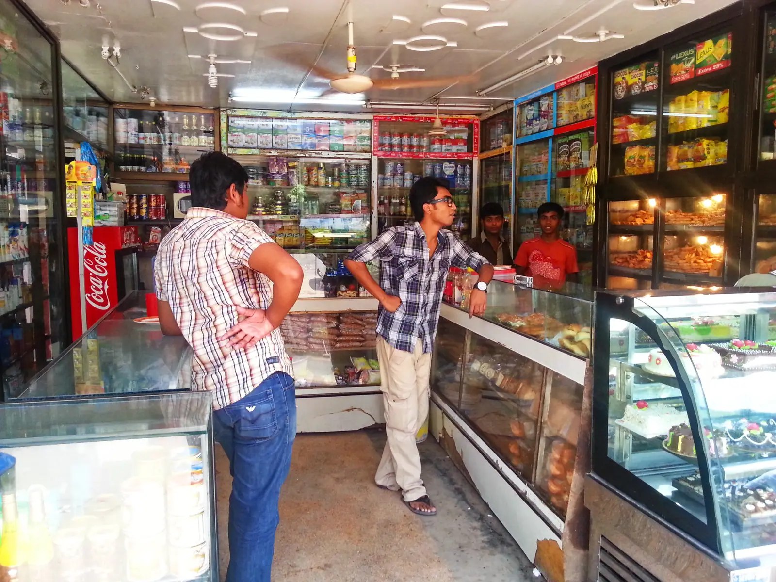 Customers waiting at the counter inside a convenience shop in Comilla, Bangladesh.
