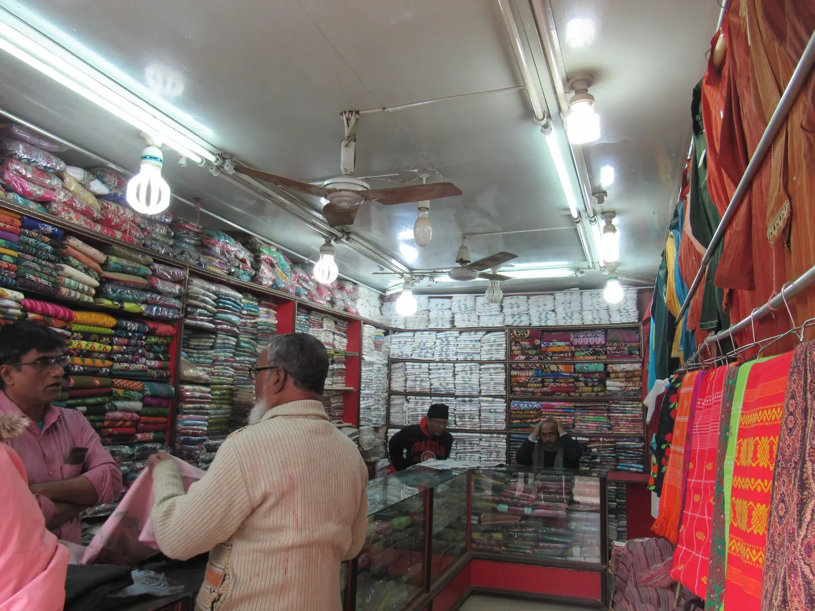 Khadi clothing shops in Kandirpar, Comilla, garments hanging across the shopfronts.